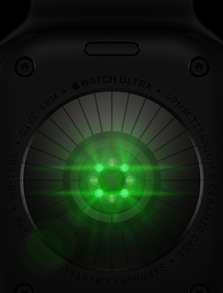 „Apple Watch Ultra 4“ nugarėlė, titano korpusas, juodos spalvos, keli užapvalinti jutikliai su švytinčiomis žaliomis LED lemputėmis