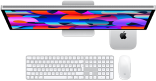 Mac mini tucked under Studio Display, Magic Keyboard with Numeric Keypad, Magic Mouse