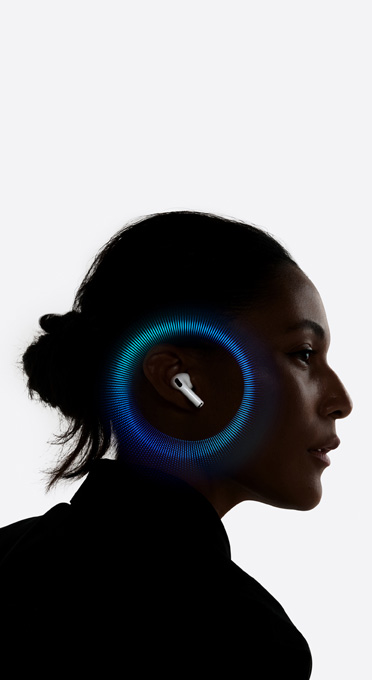 A person wearing AirPods Pro 3 with sound waves around their ear