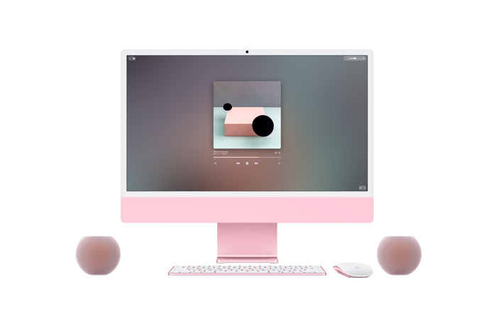 Pink iMac, front exterior, Apple Music playing on screen, color-matched Magic Keyboard and Magic Mouse, flanked by two pink HomePod mini 2 speakers in a stereo pair setup