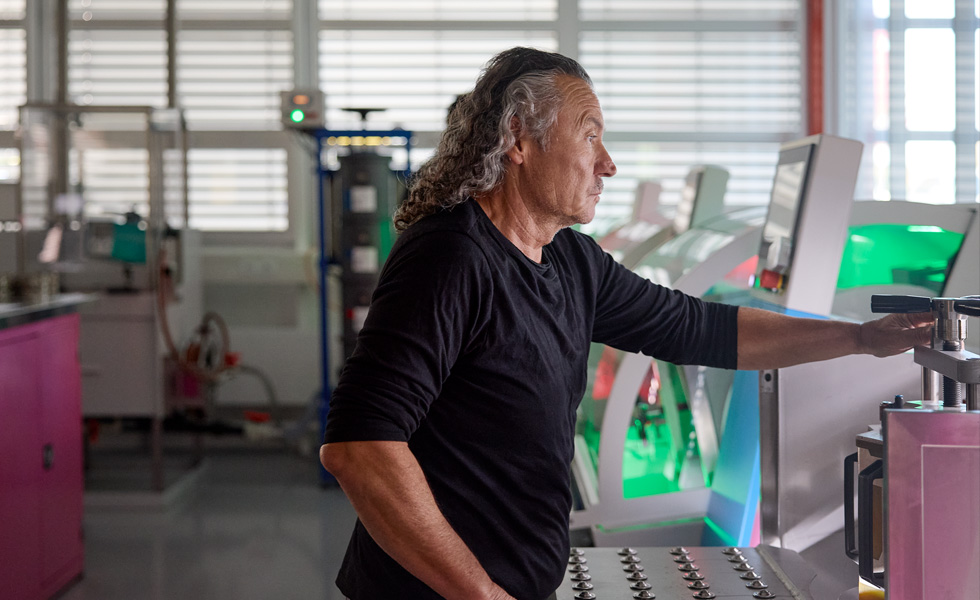 An employee works in front of component machinery